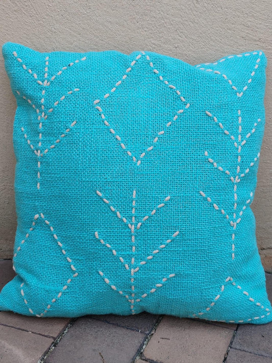 Coussin artisanal en coton turquoise